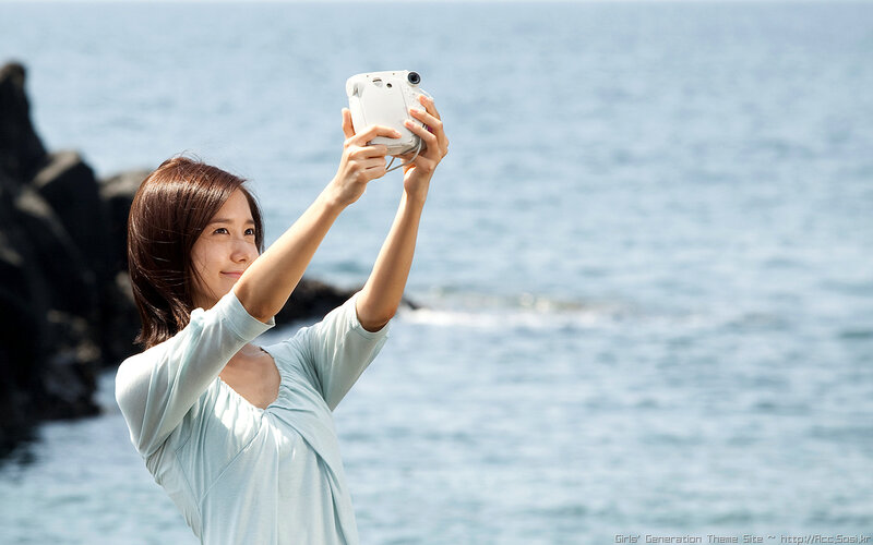 woman taking selfie by the sea