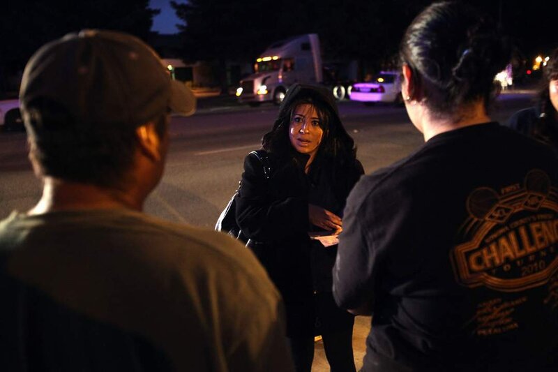 Woman Talking to Two People