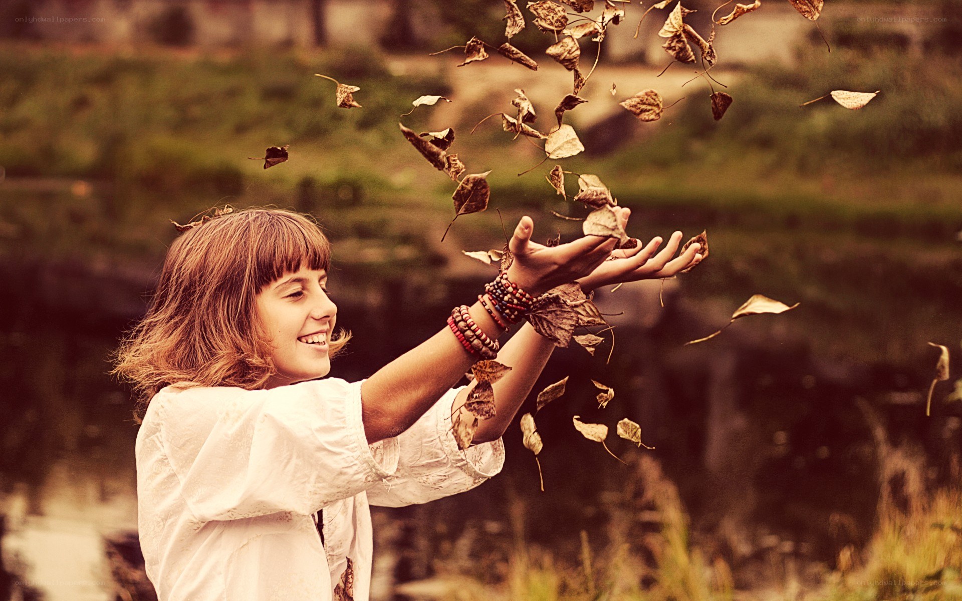woman throwing autumn leaves