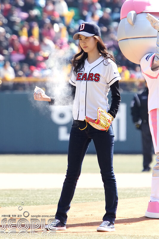 woman throwing first pitch