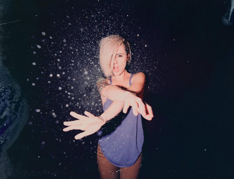 woman throwing powder in dark room