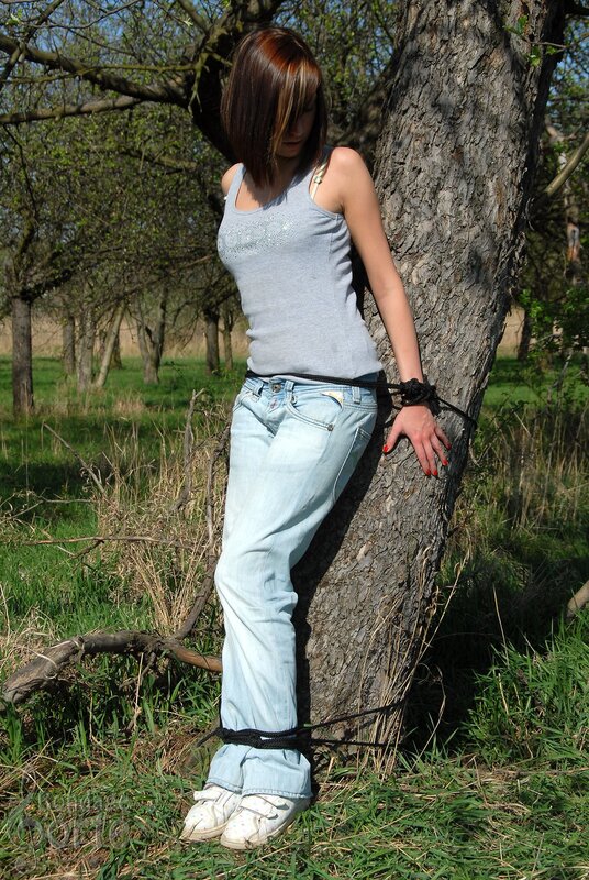 Woman tied to a tree