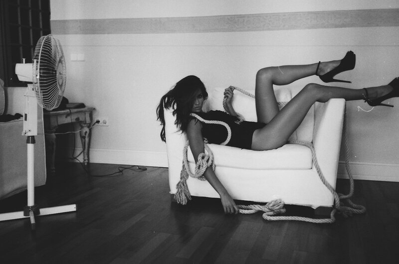 woman tied with rope on couch