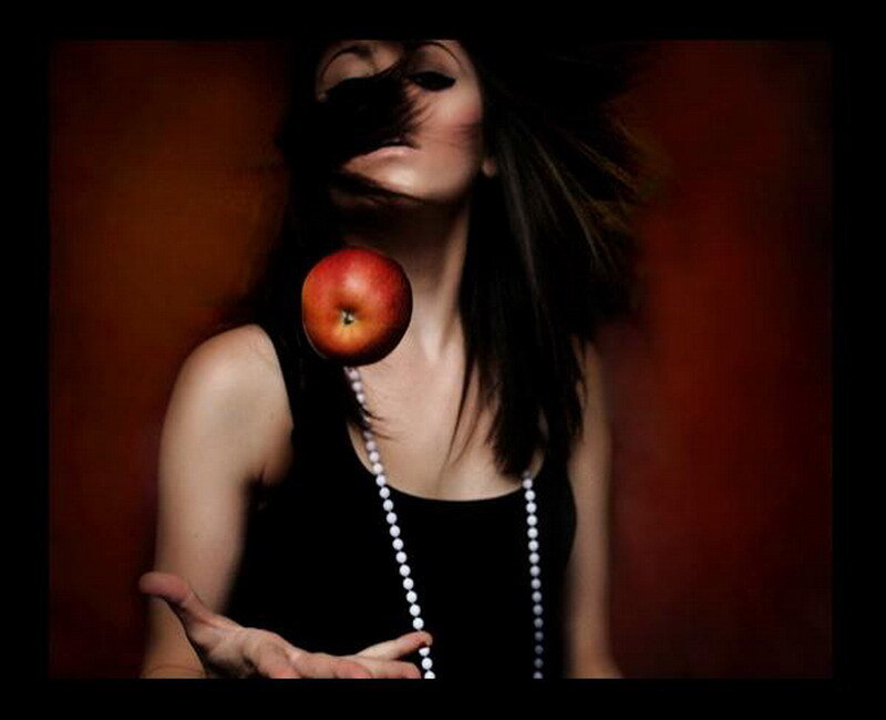 woman tossing an apple