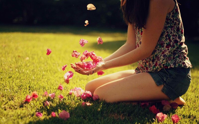 woman tossing flower petals