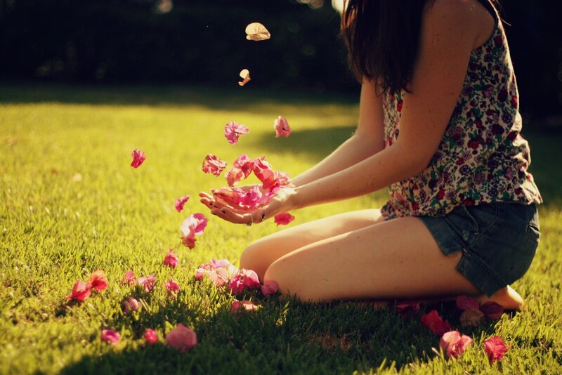 woman tossing flower petals