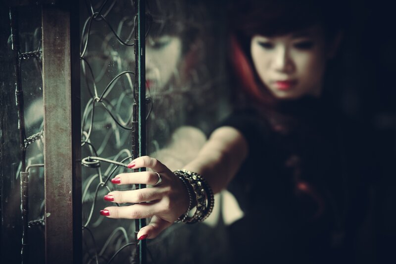 woman touching glass with red nails