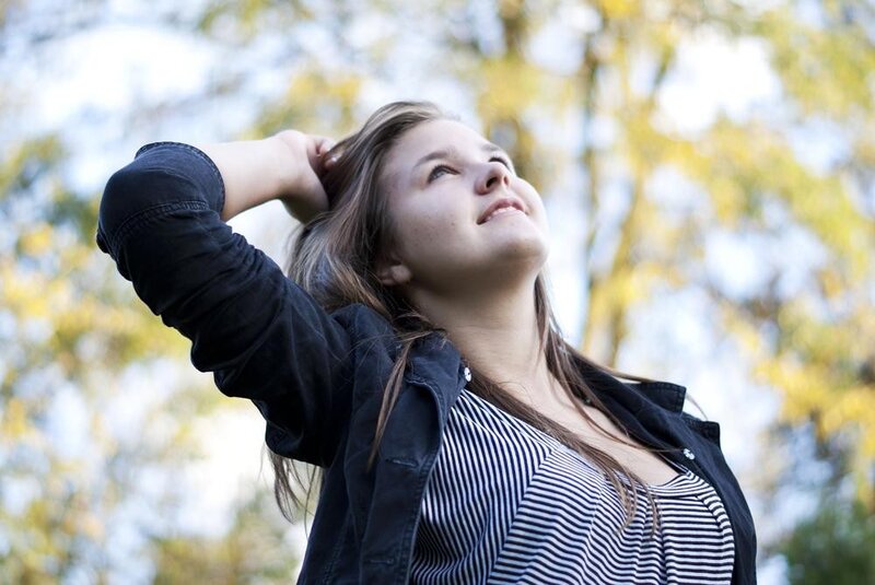 woman touching hair outdoors