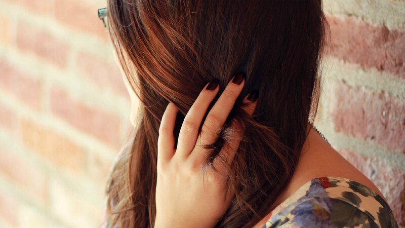 woman touching her hair