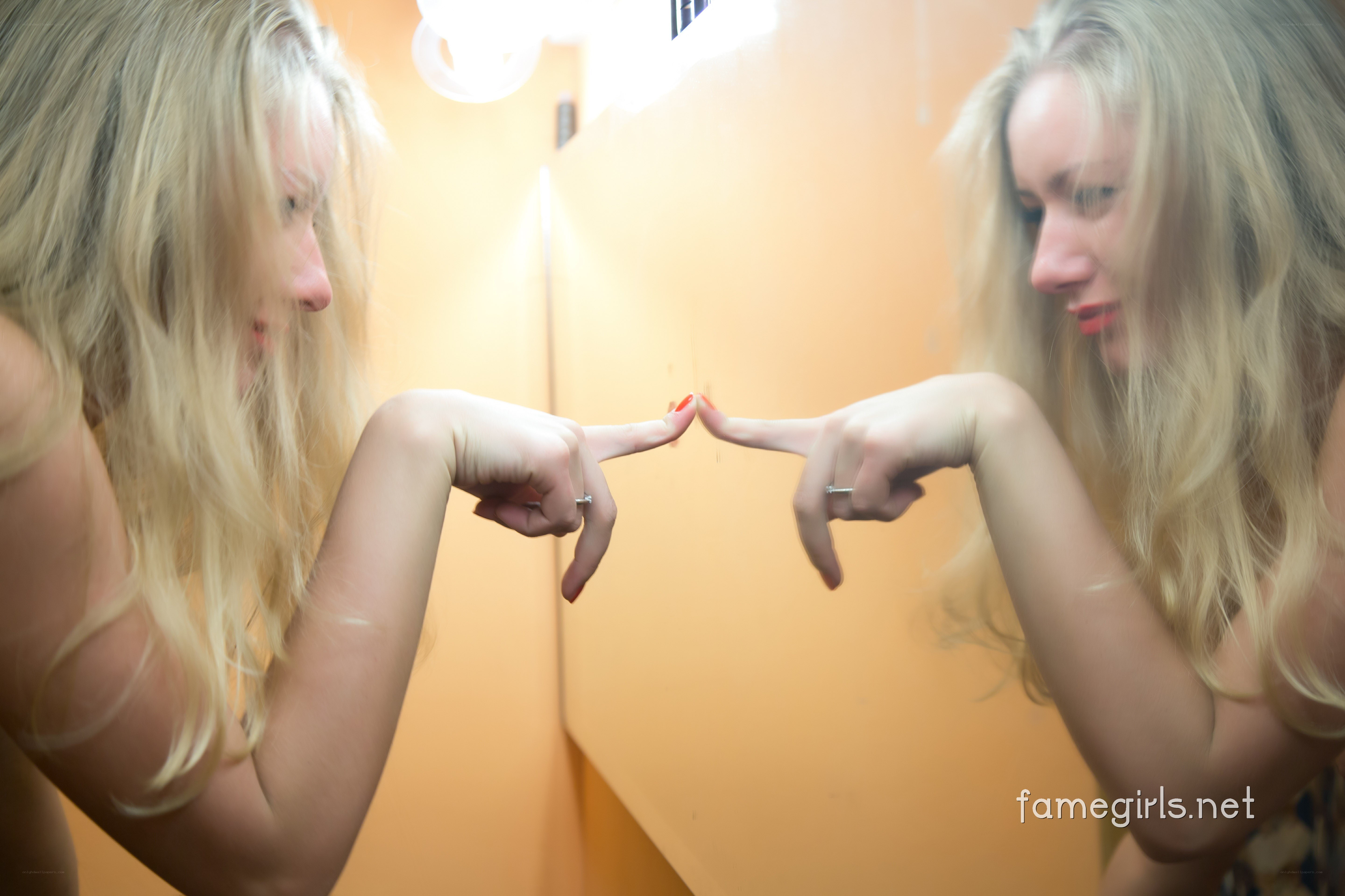 woman touching mirror