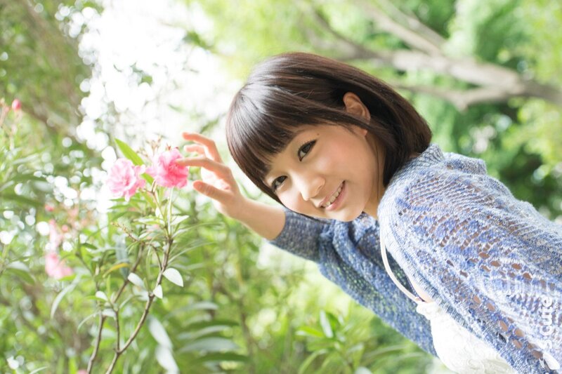 woman touching pink flowers