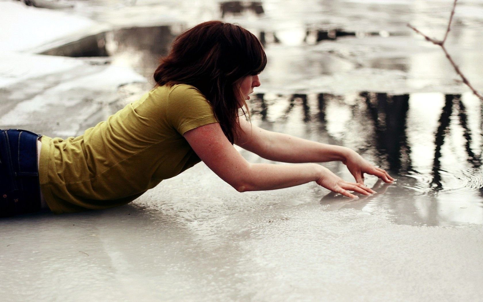 woman touching water on ice
