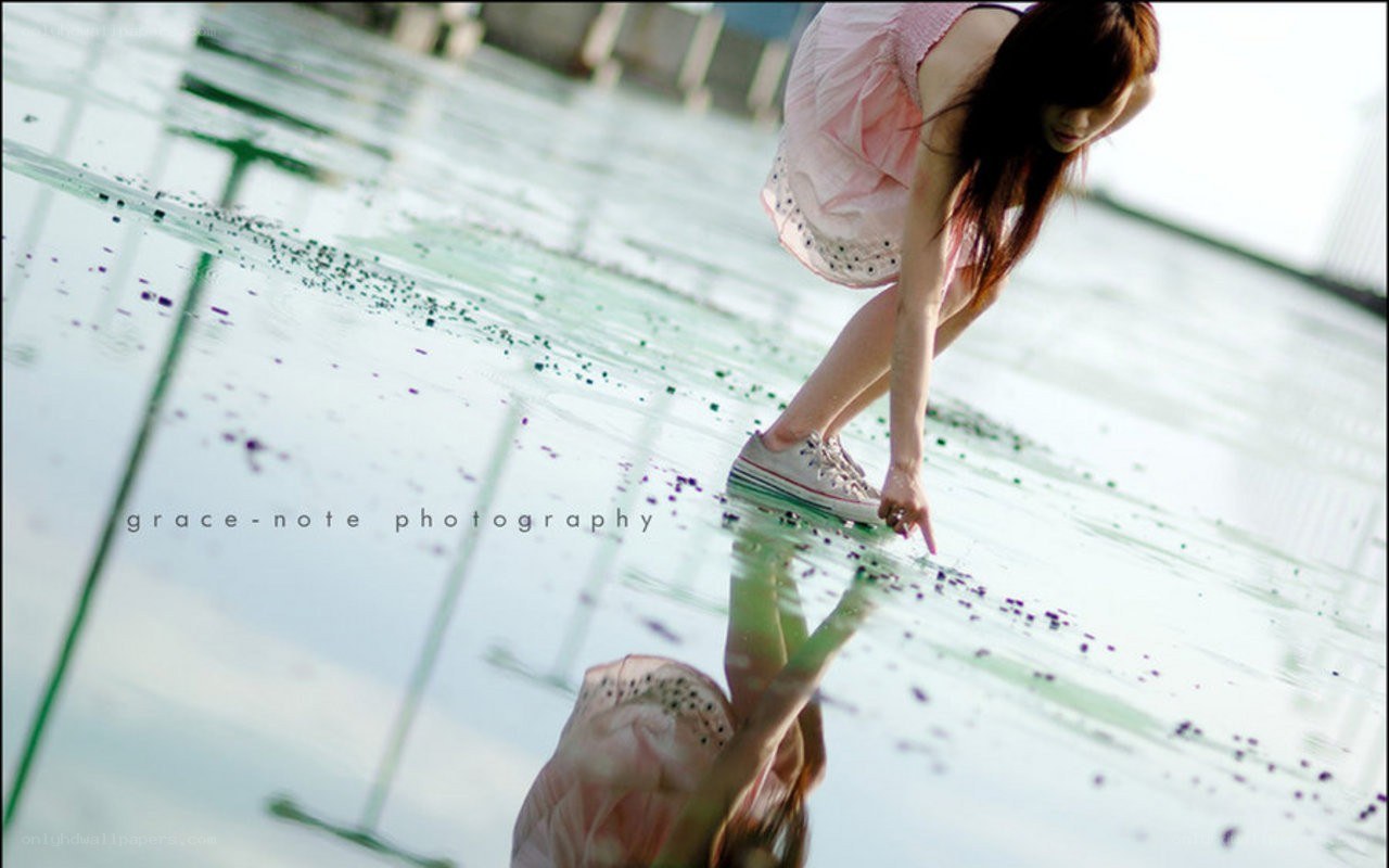 woman touching water surface