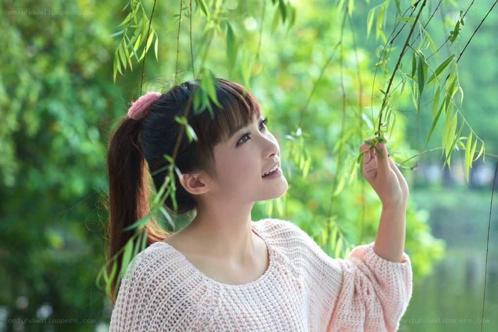 woman touching willow branches