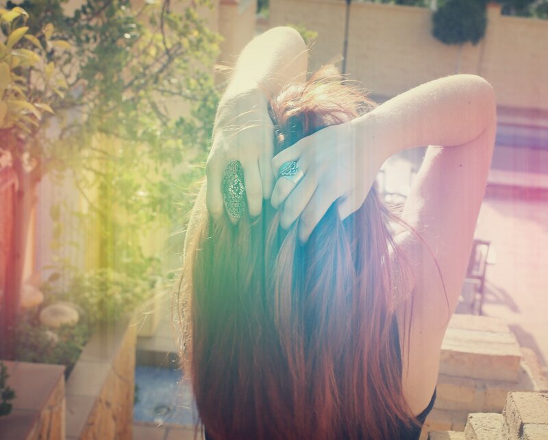 woman tying her hair back