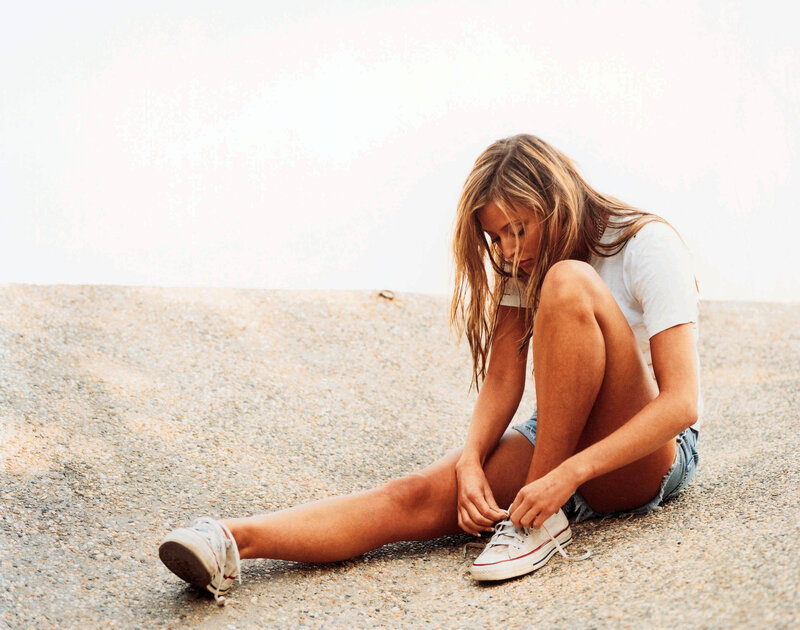 woman tying her shoes