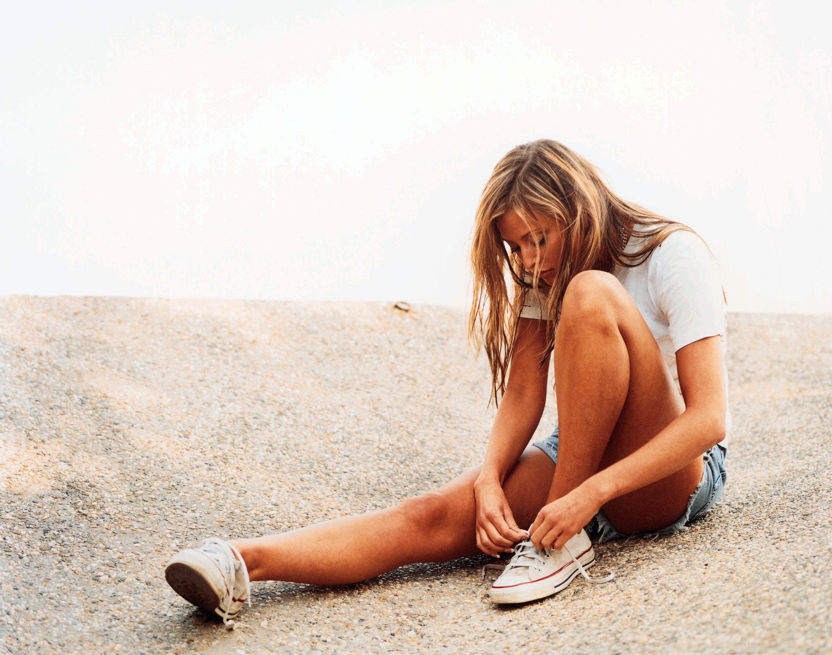 woman tying her shoes