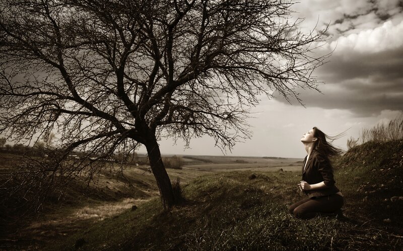 Woman under a bare tree