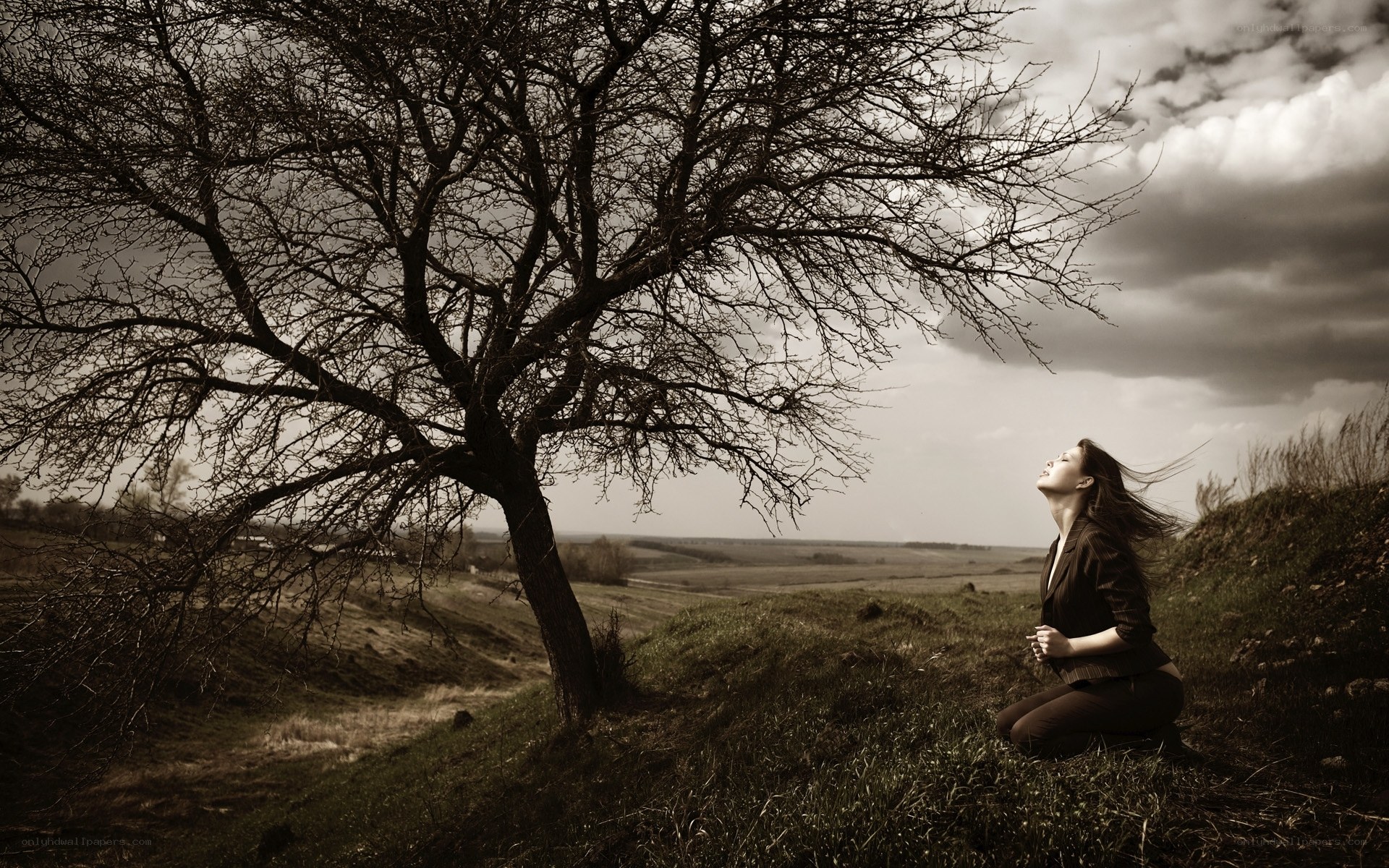 Woman under a bare tree