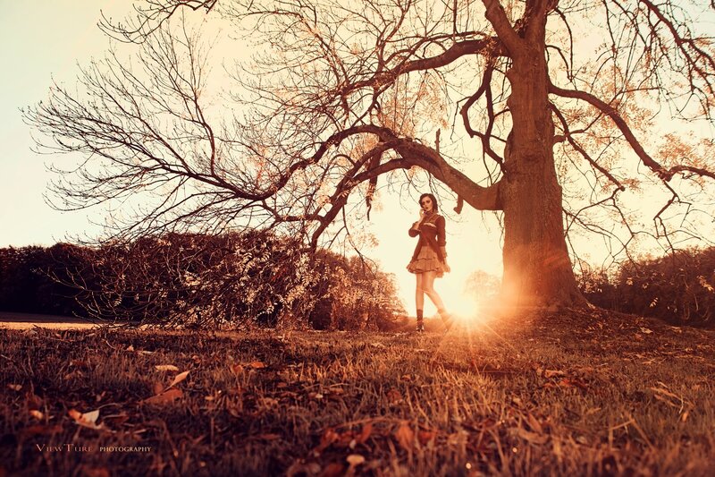 woman under a tree at sunset