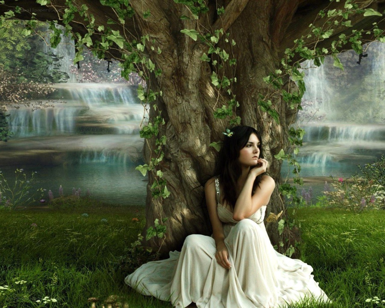 Woman under a tree by waterfall