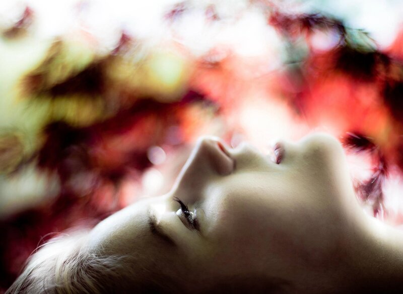 woman under autumn leaves