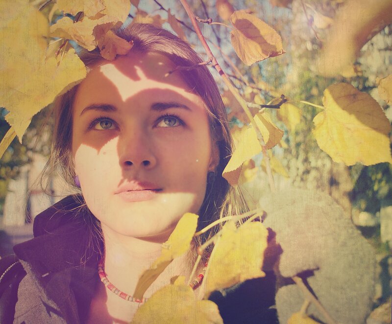 woman under autumn leaves