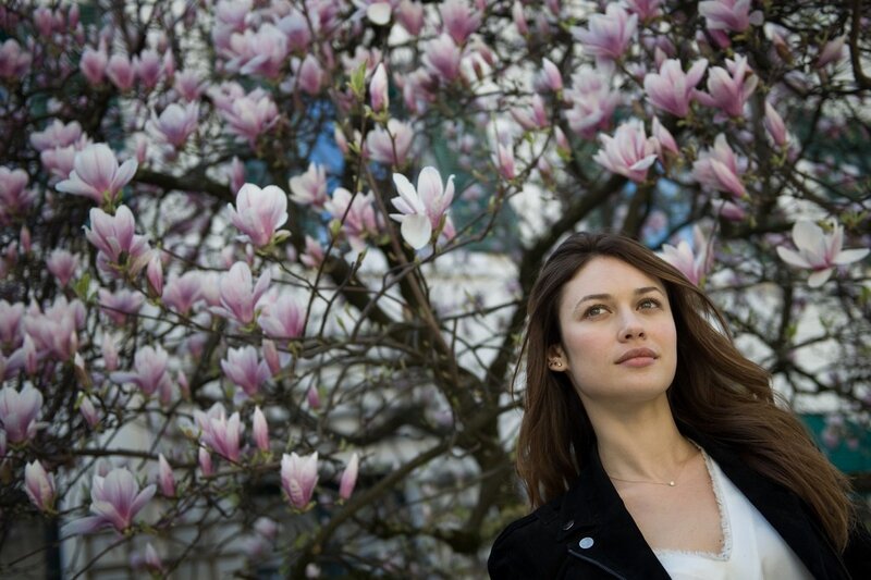 woman under blooming magnolia tree