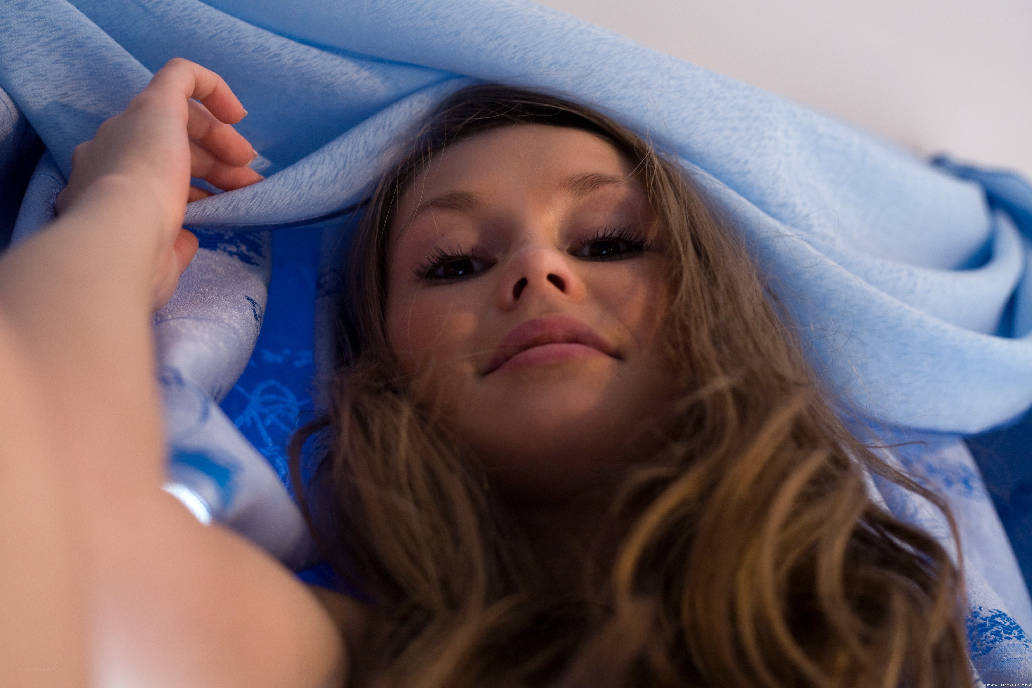 woman under blue blanket