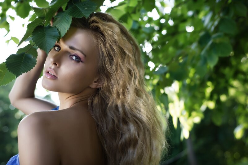 woman under green leaves
