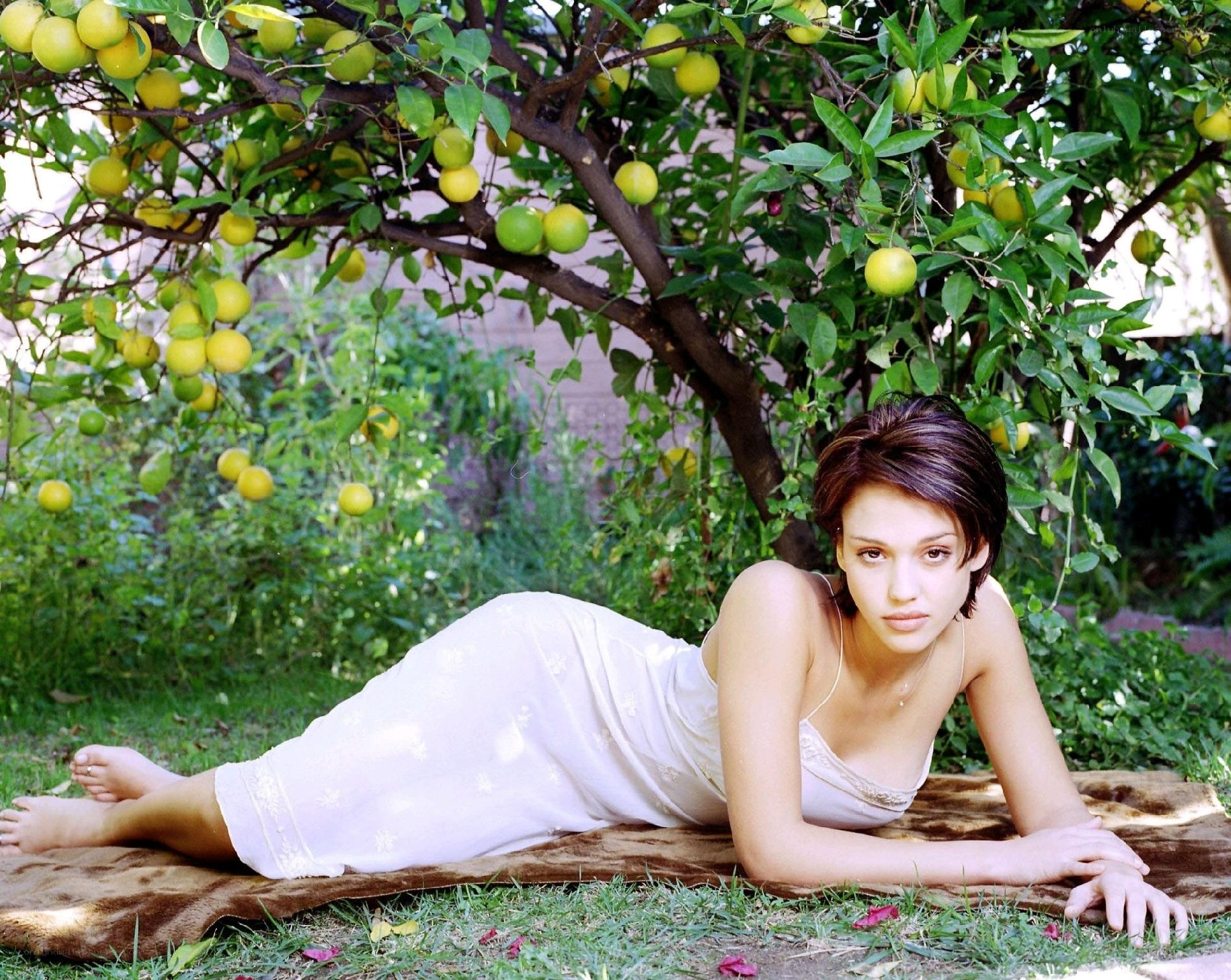 Woman under lemon tree