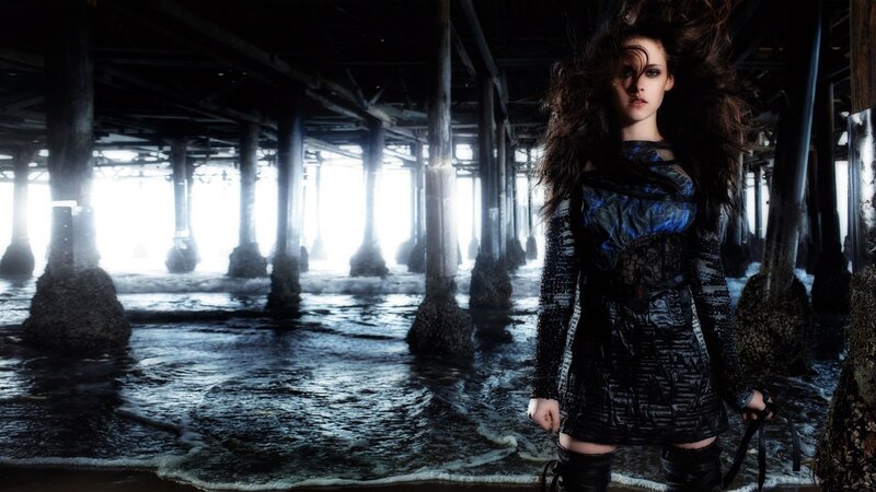woman under pier at night