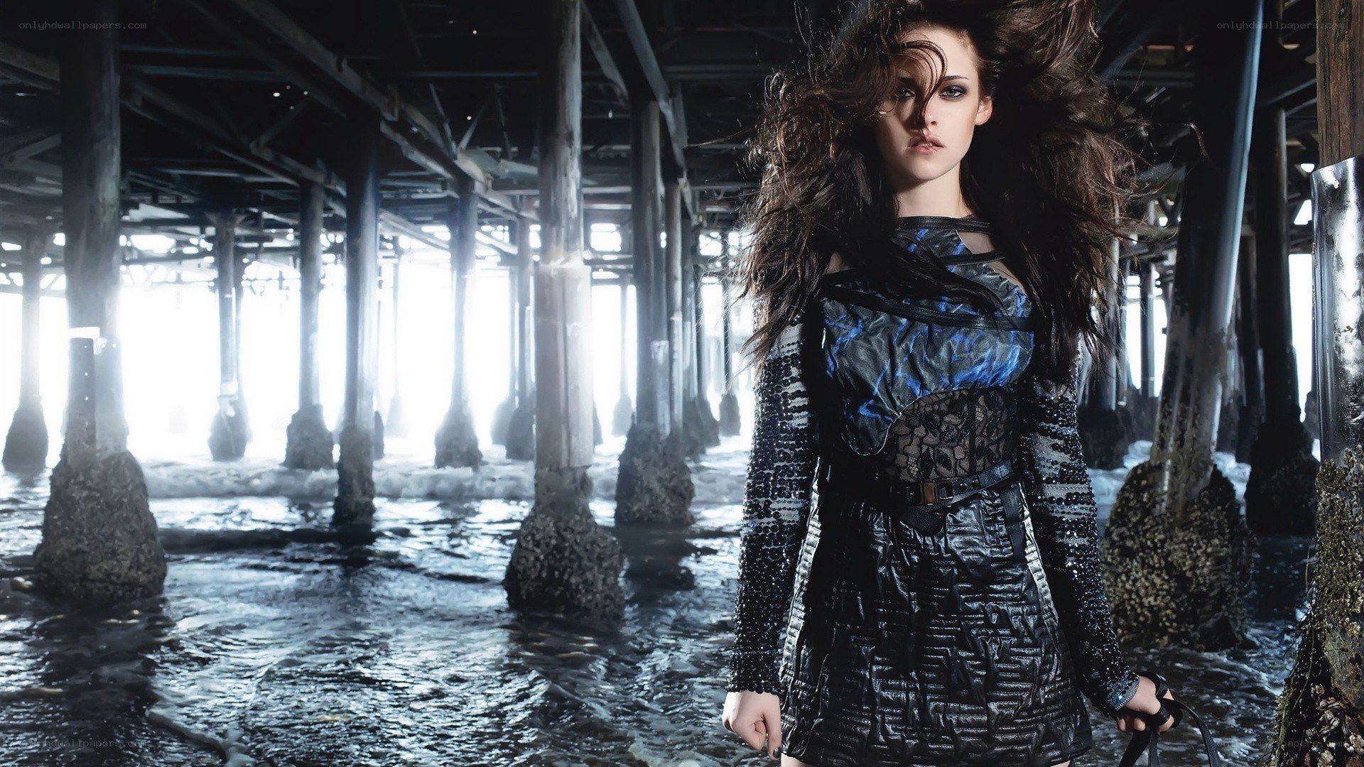 woman under pier in dramatic lighting