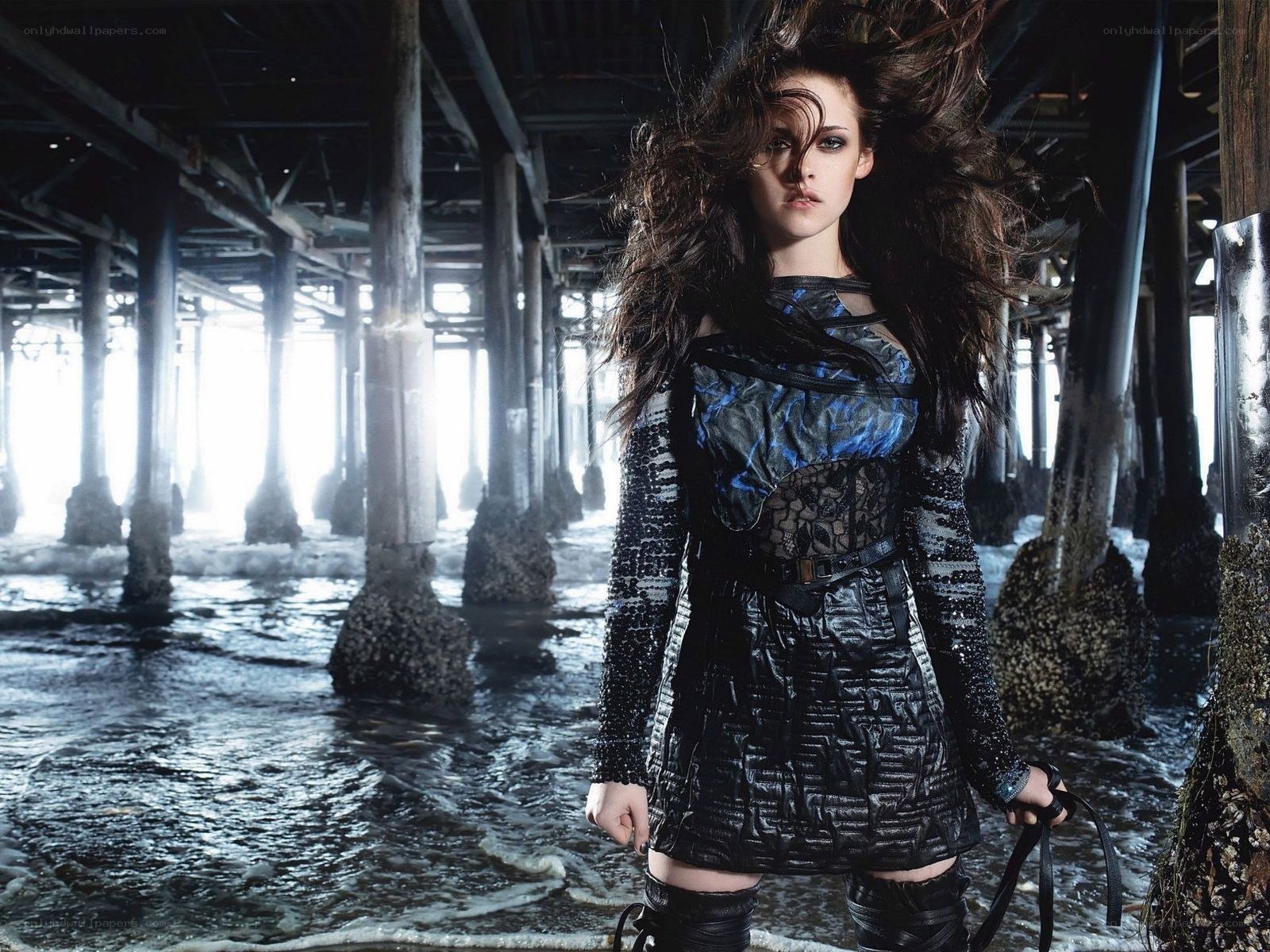 woman under pier in dramatic pose