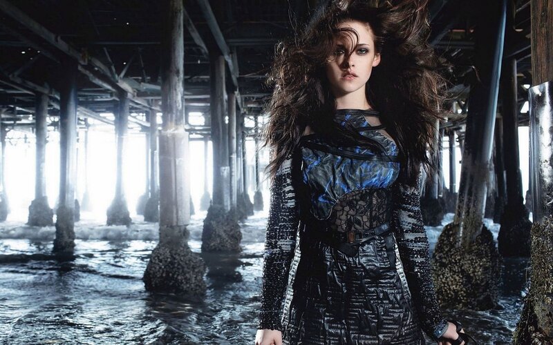 woman under pier with wind-blown hair