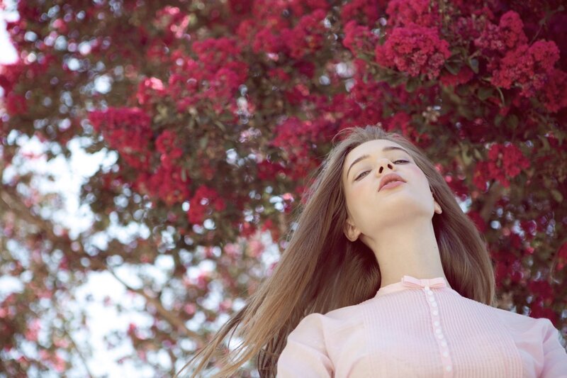 woman under pink blossoms