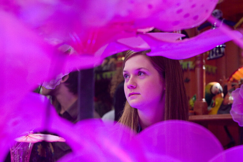 woman under purple flowers