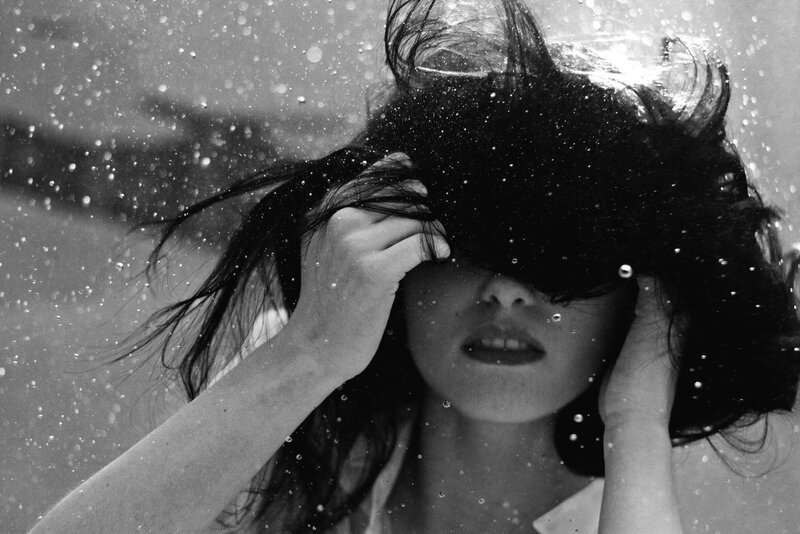 woman under rain with hands on head