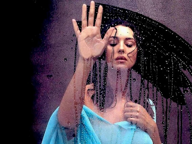 woman under rain with umbrella