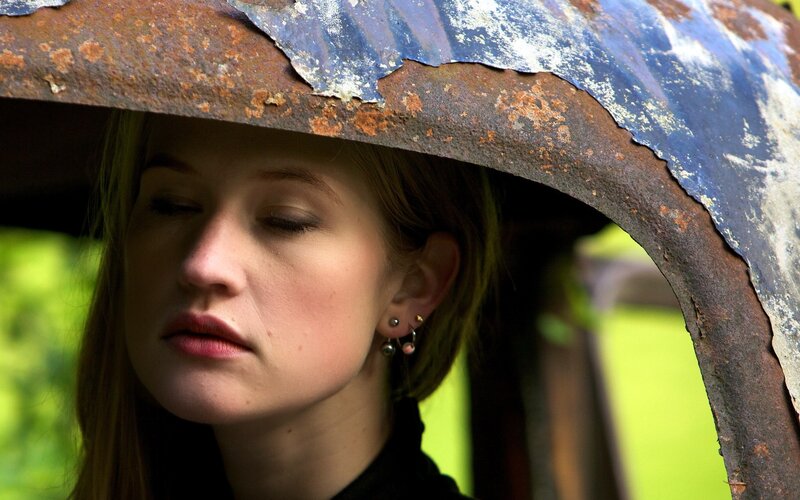woman under rusted metal