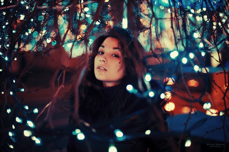 woman under string lights