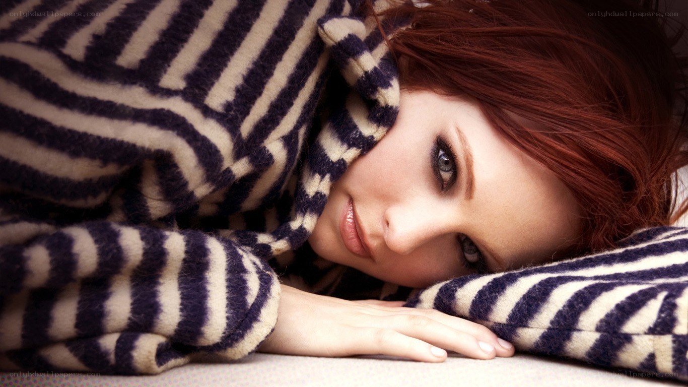 woman under striped blanket