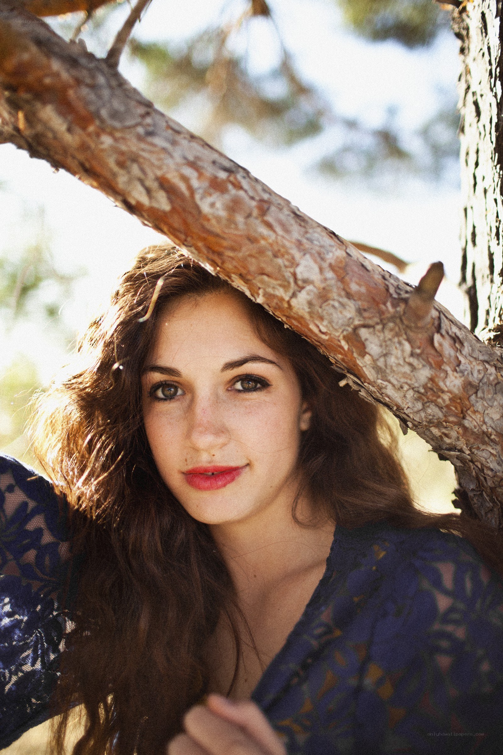 woman under tree branch
