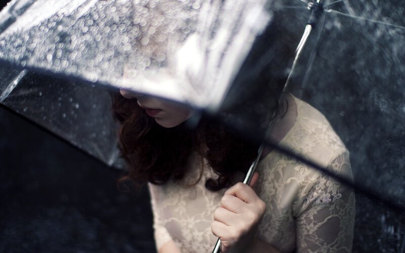 woman under umbrella in rain