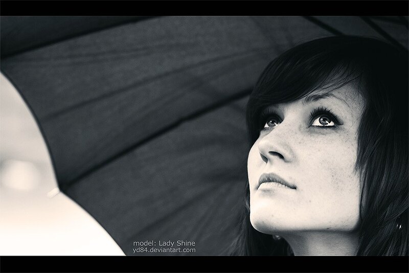 woman under umbrella looking up