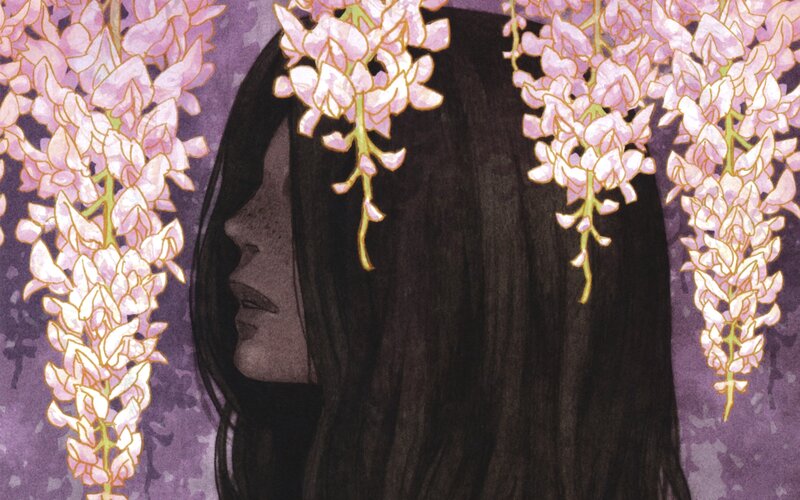 woman under wisteria flowers