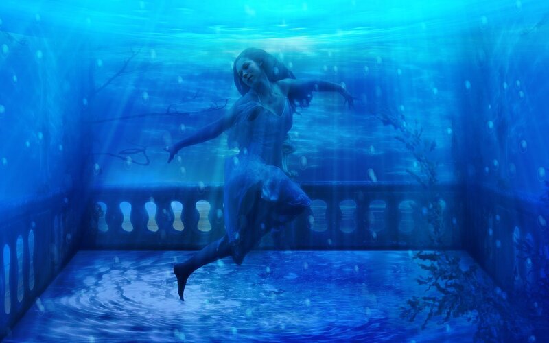 woman underwater in blue light
