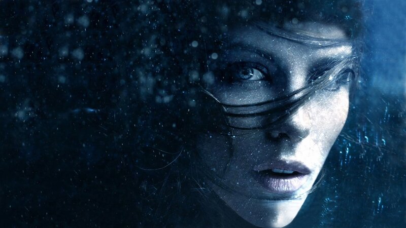 woman underwater in blue light