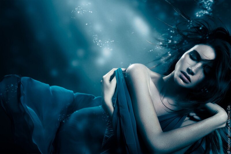 woman underwater in blue light