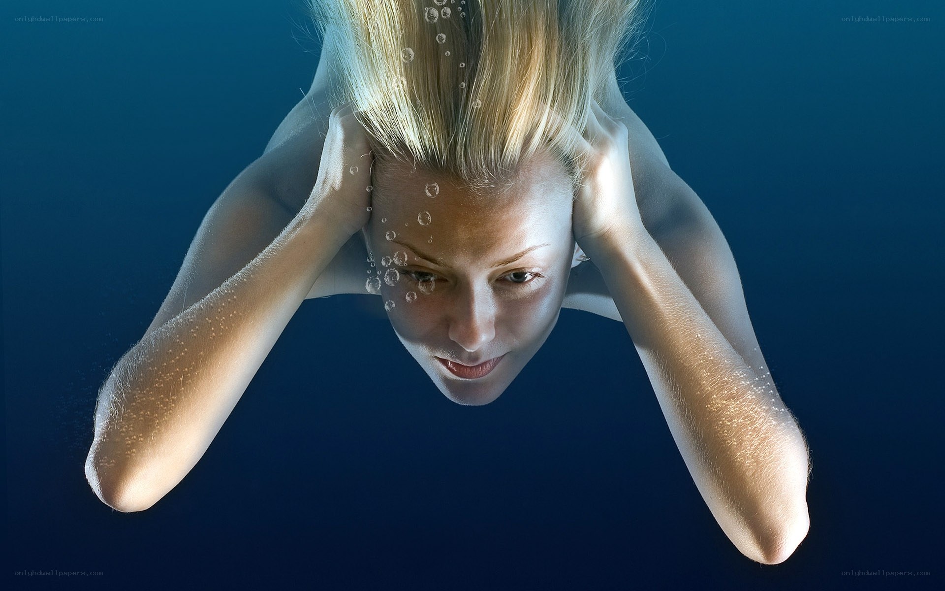 woman underwater with bubbles